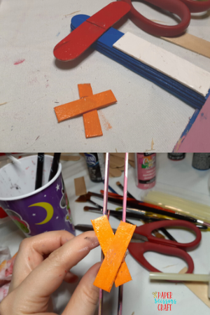 Popsicle stick airplane orange propeller example.