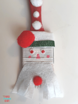 Paintbrush Santa ornament with face painted on.