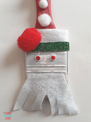 Santa paintbrush ornament with beard and googly eyes.