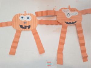 Pumpkin people made with orange construction paper.