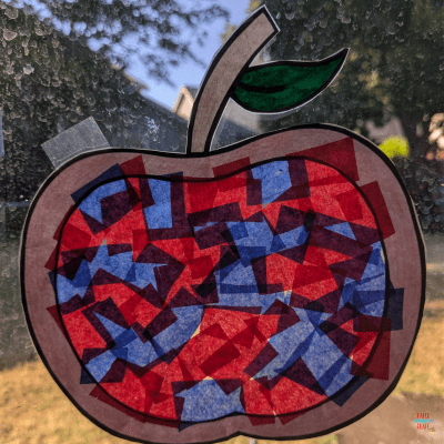 Apple suncatcher craft hanging on a window.