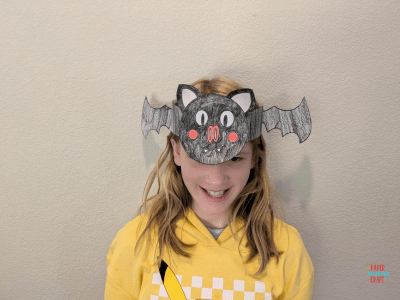 Girl wearing a bat headband.