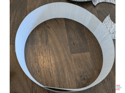 Top of paper headband on wooden floor.