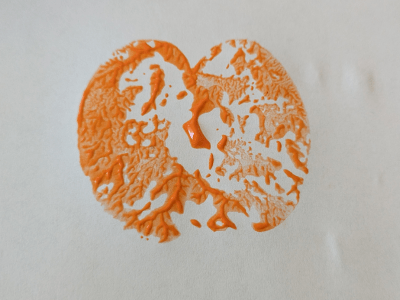 Apple stamp example using orange paint.