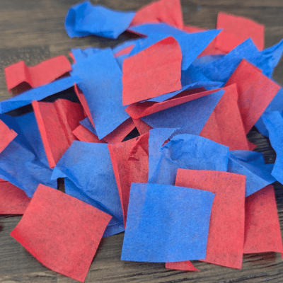 Pieces of red and blue tissue paper cut into small squares.