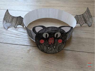 Finished bat headband craft on a wooden floor.