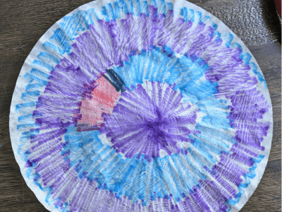 Coffee filter colored with blue, purple, and red markers.