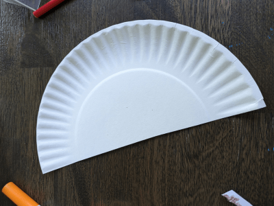 White paper plate folded in half.