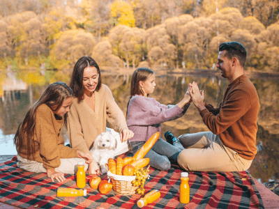 Family of four enjoying a fall picnic.