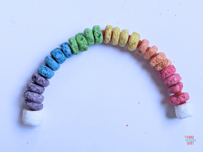 Froot Loops rainbow pipe cleaner craft with marshmallows on the end.