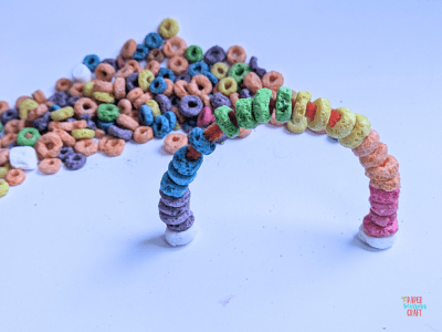 Finished Froot Loops pipe cleaner rainbow craft standing on its own.