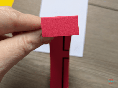 Red paper cut into a strip and 1 inch folded at the end.